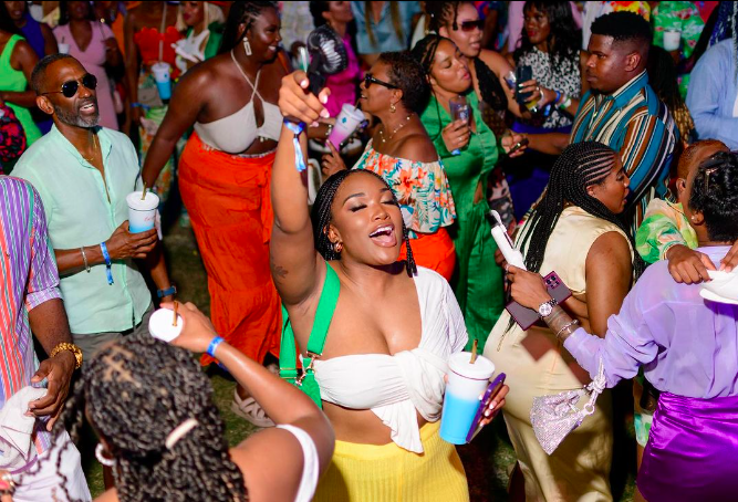 An attractive woman eyes closed dancingsinging and enjoying herself at a fete